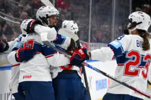 Team USA hockey players Britta Curl-Salemme, Cayla Barnes, Abbey Murphy, and Hannah Bilka celebrate a goal during the third game of the 2025 Rivalry Series against Canada.