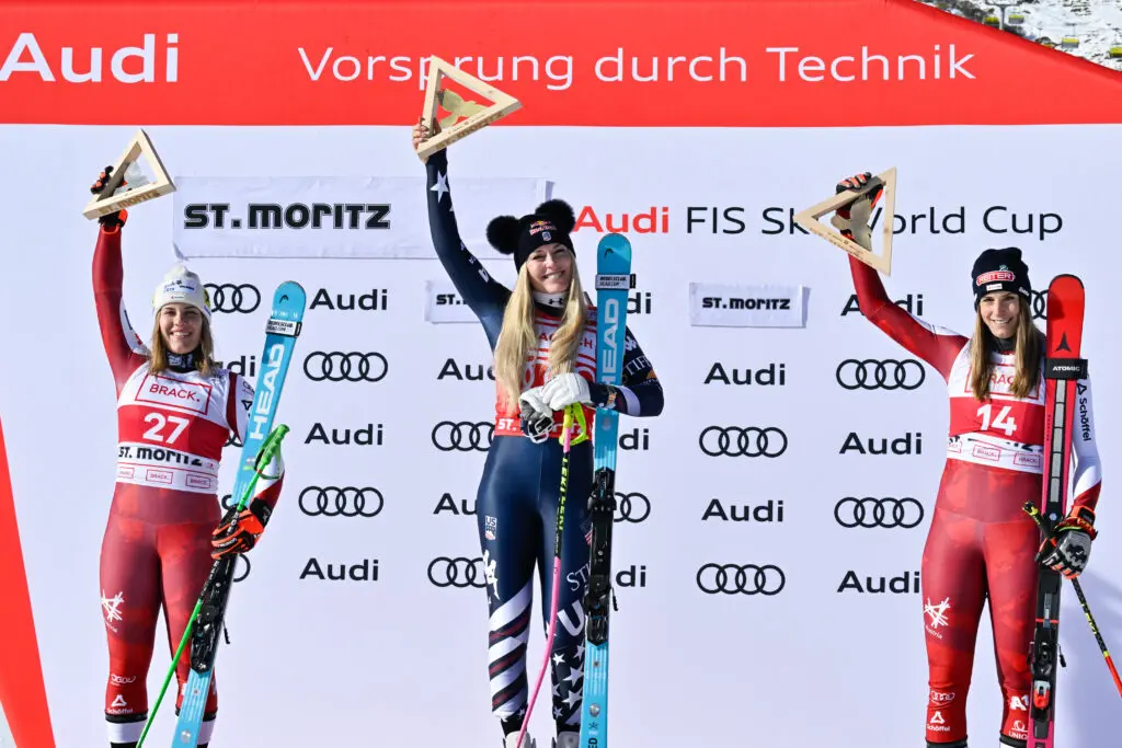 USA ski star Lindsey Vonn tops the St. Moritz Alpine World Cup podium between second-place Magdalena Egger and thrid-place Mirjam Puchner in December 2025.