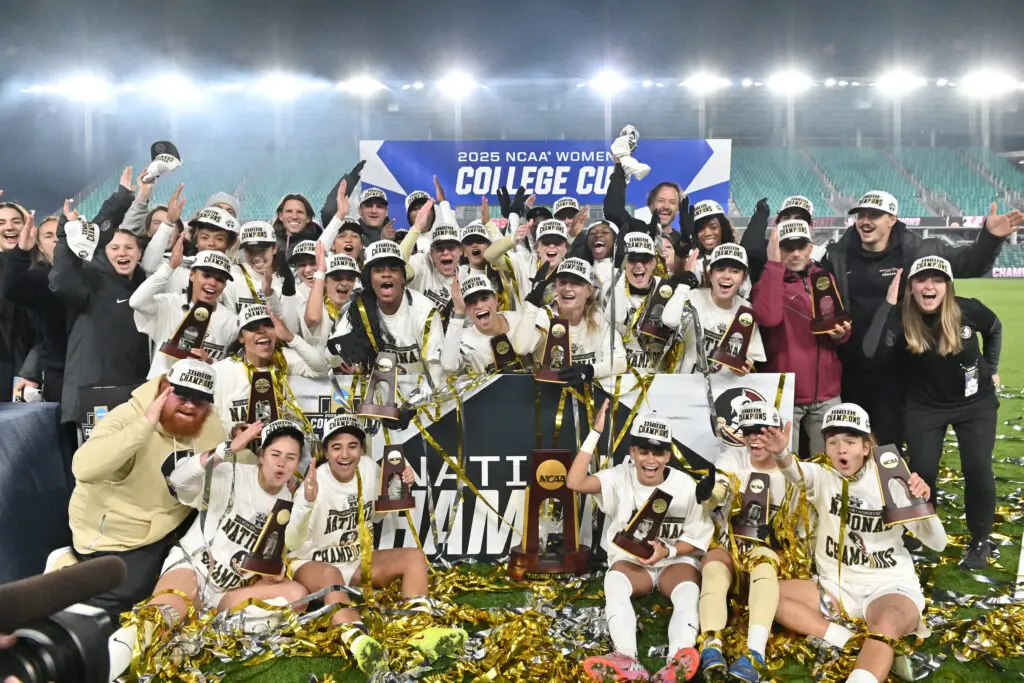 Florida State women's soccer players and staff pose with their NCAA championship trophies after winning the 2025 College Cup.