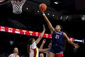 UConn star forward Sarah Strong shoots the ball over USC defenders during a 2025/26 NCAA basketball game.