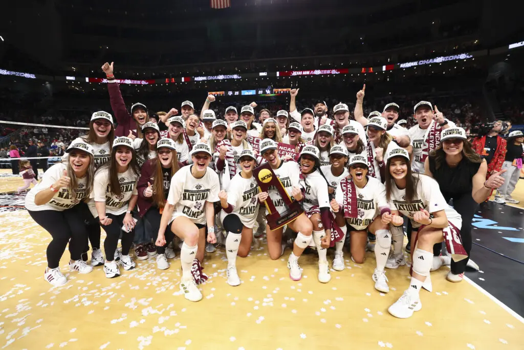 Texas A&M volleyball poses for a photo celebrating their 2025 NCAA championship win.