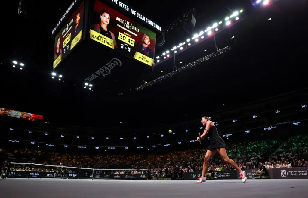 World No. 1 Aryna Sabalenka plays a backhand against ATP player Nick Kyrgios during a 2025 Battle of the Sexes exhibition match in Dubai.