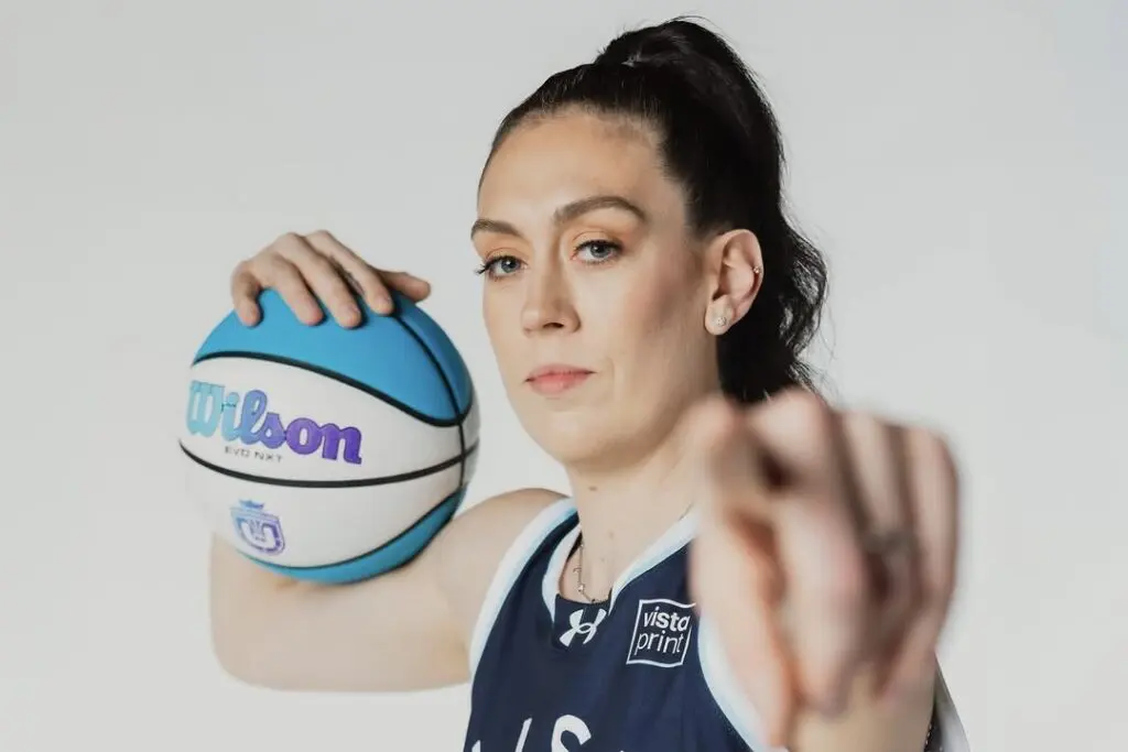 Mist BC star Breanna Stewart points and poses with a basketball during an Unrivaled photo shoot.