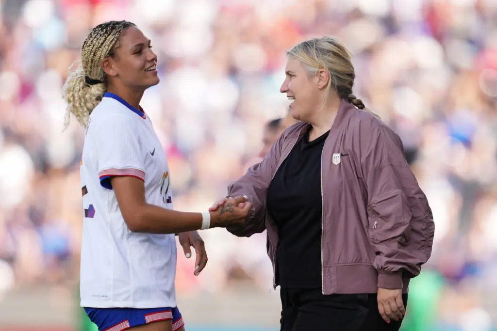 USWNT head coach Emma Hayes shakes hands with forward Trinity Rodman during a 2024 match.