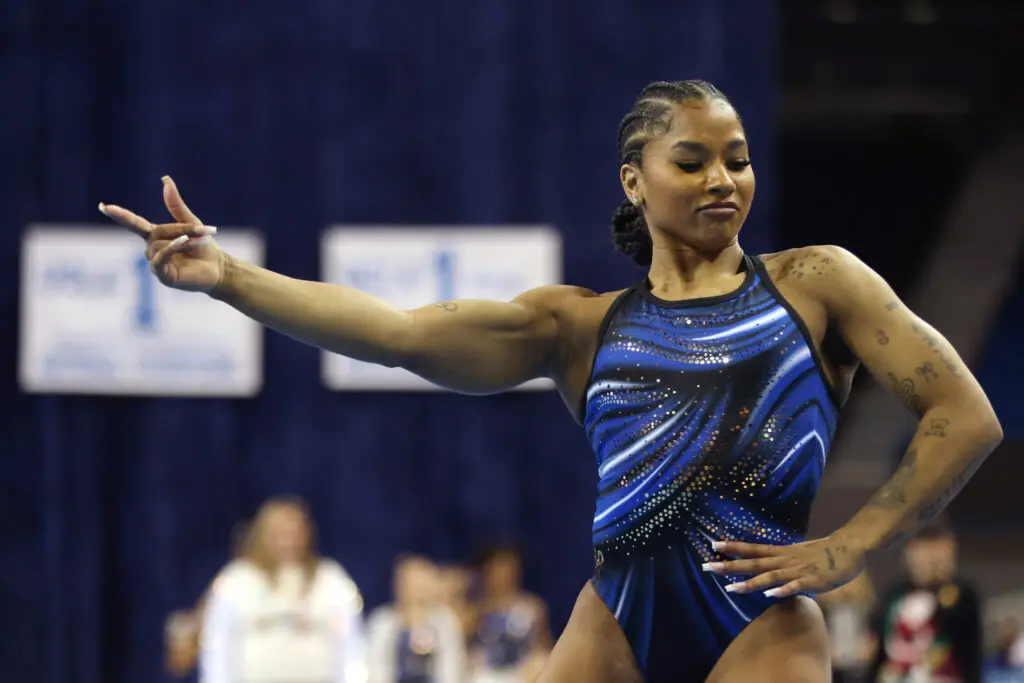 UCLA gymnast Jordan Chiles strikes a pose during her floor routine at a December 2025 exhibition meet.