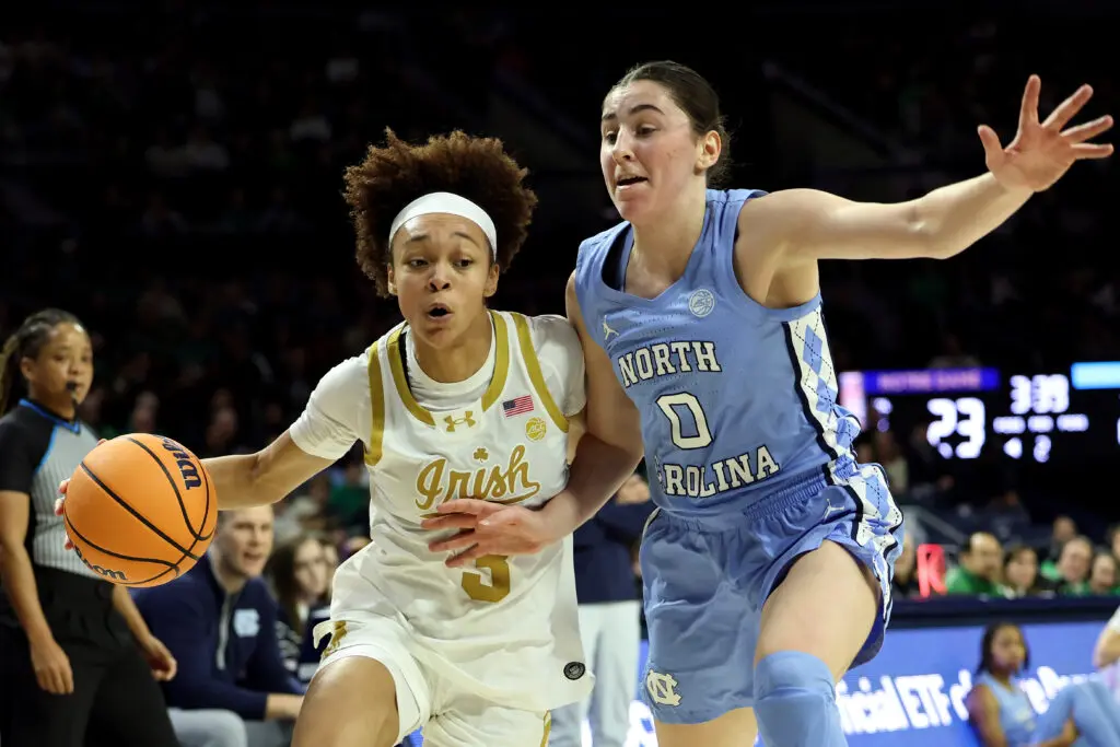 Notre Dame junior guard Hannah Hidalgo dribbles around UNC sophomore guard Lanie Grant during a 2025/26 NCAA basketball game.