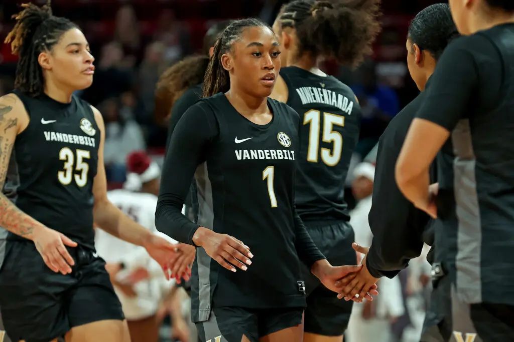 Vanderbilt sophomore guard Mikayla Blakes high-fives a coach during a timeout in a 2025/26 NCAA basketball game.