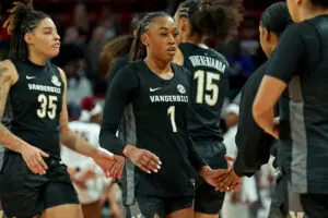 Vanderbilt sophomore guard Mikayla Blakes high-fives a coach during a timeout in a 2025/26 NCAA basketball game.