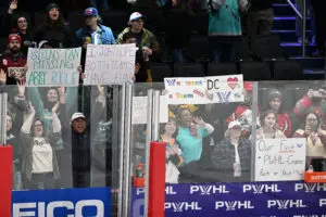 Fans hold signs and cheer during a 2025/26 PWHL Takeover Tour game in Washington, DC.