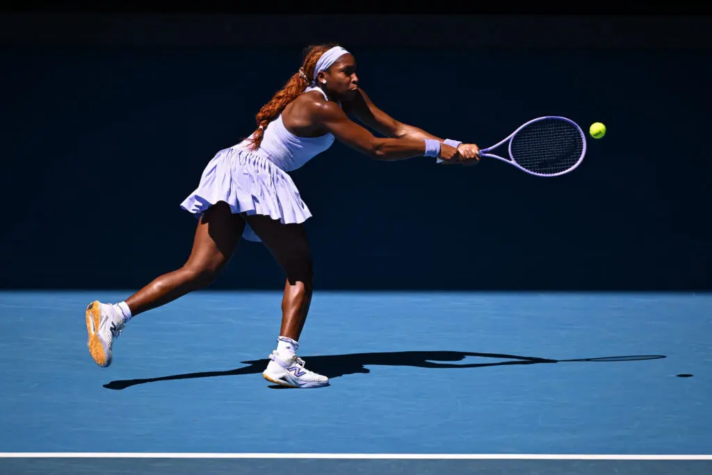 US tennis star Coco Gauff reaches for a backhand volley during her opening match at the 2026 Australian Open.