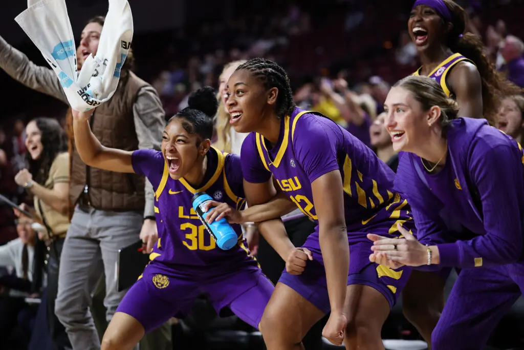LSU women's basketball players celebrate and cheer from the bench during a 2025/26 NCAA game.