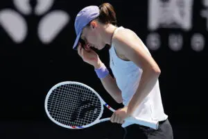 Polish tennis star Iga Świątek hangs her head during her 2026 Australian Open quarterfinals loss.