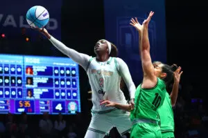 Rose BC guard Kahleah Copper drives past Phantom BC guard Kelsey Plum to lay up a shot during a 2026 Unrivaled game.