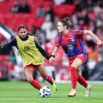 Emily Fox #23 of the United States is marked by Alyssa Thompson #7 during warmups prior to the Women's international friendly between England and the USA at Wembley Stadium on November 30, 2024 in London, England.