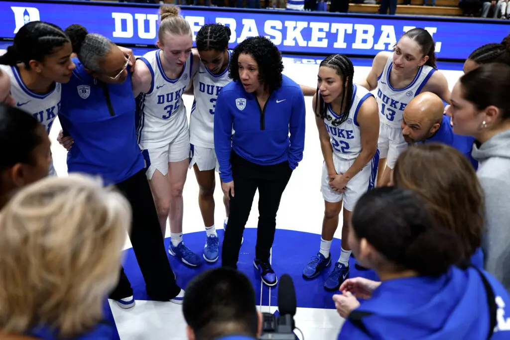 Duke head coach Kara Lawson speaks to her team in a huddle after a 2025/26 NCAA basketball game.
