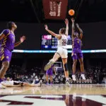 LSU star Flau'jae Johnson shoots over Texas A&M forward Lauren Ware during a 2025/26 NCAA basketball game.