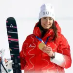 Mathilde Gremaud celebrates first place with her Winter Olympics gold medal at the award ceremony.
