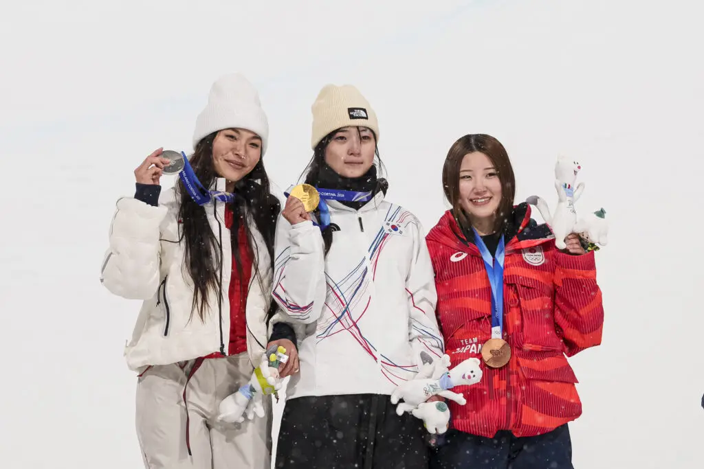 USA snowboard star Chloe Kim, South Korea's Gaon Choi, and Japan's Mitsuki Ono pose with their 2026 Olympic medals after the women's halfpipe event.
