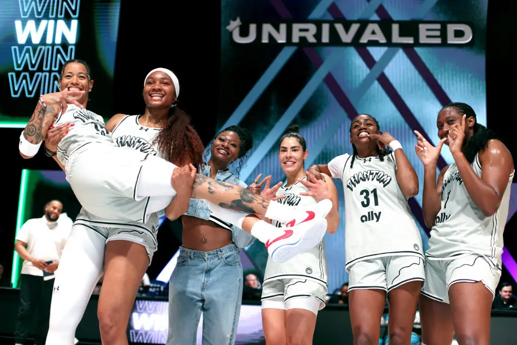 Phantom BC's Natasha Cloud, Kiki Iriafen, Dana Evans, Kelsey Plum, Tiffany Hayes, and Aliyah Boston smile and pose after a win in the 2026 Unrivaled season.