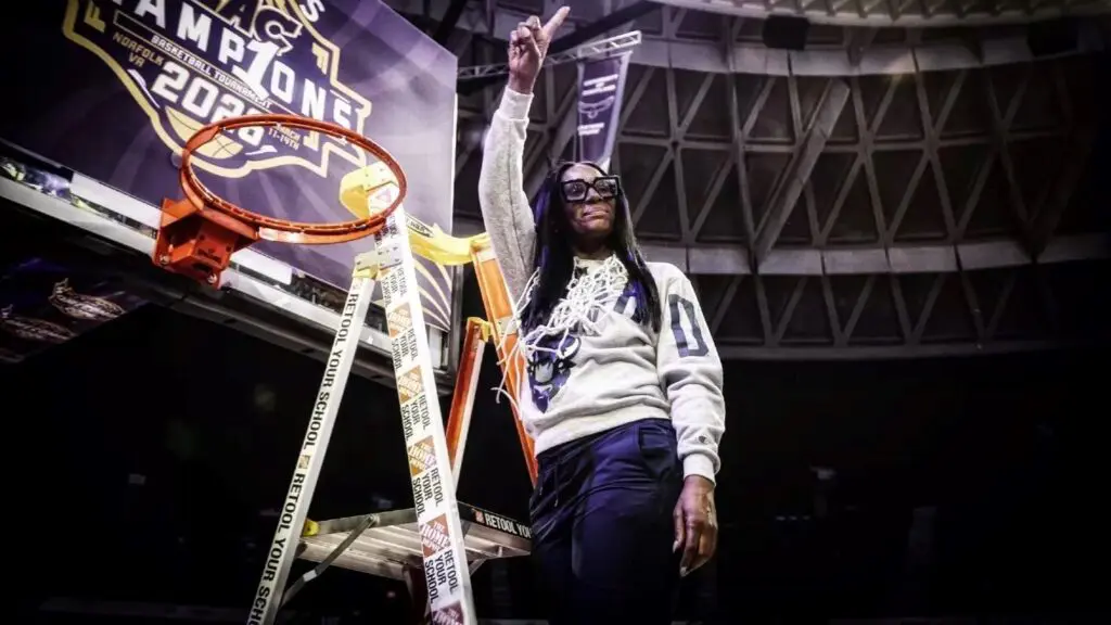 Howard women's basketball coach Ty Grace poses by the hoop after Howard basketball won the 2026 MMEAC championship.