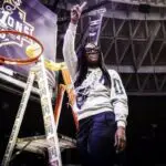 Howard women's basketball coach Ty Grace poses by the hoop after Howard basketball won the 2026 MMEAC championship.