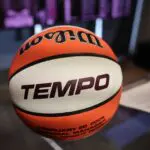 A close-up of a ceremonial basketball reading "Tempo" in honor of the 2026 WNBA expansion team in Toronto.