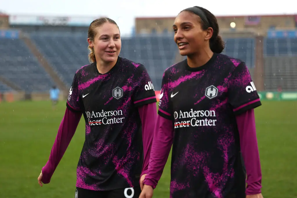 Houston Dash teammates Delanie Sheehan and Yazmeen Ryan exit the pitch after a 2025 NWSL win.