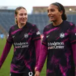 Houston Dash teammates Delanie Sheehan and Yazmeen Ryan exit the pitch after a 2025 NWSL win.