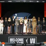 Members of the 2025 WNBA Draft class stand on stage after the event.