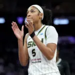 Chicago Sky star Angel Reese claps during a 2025 WNBA game.