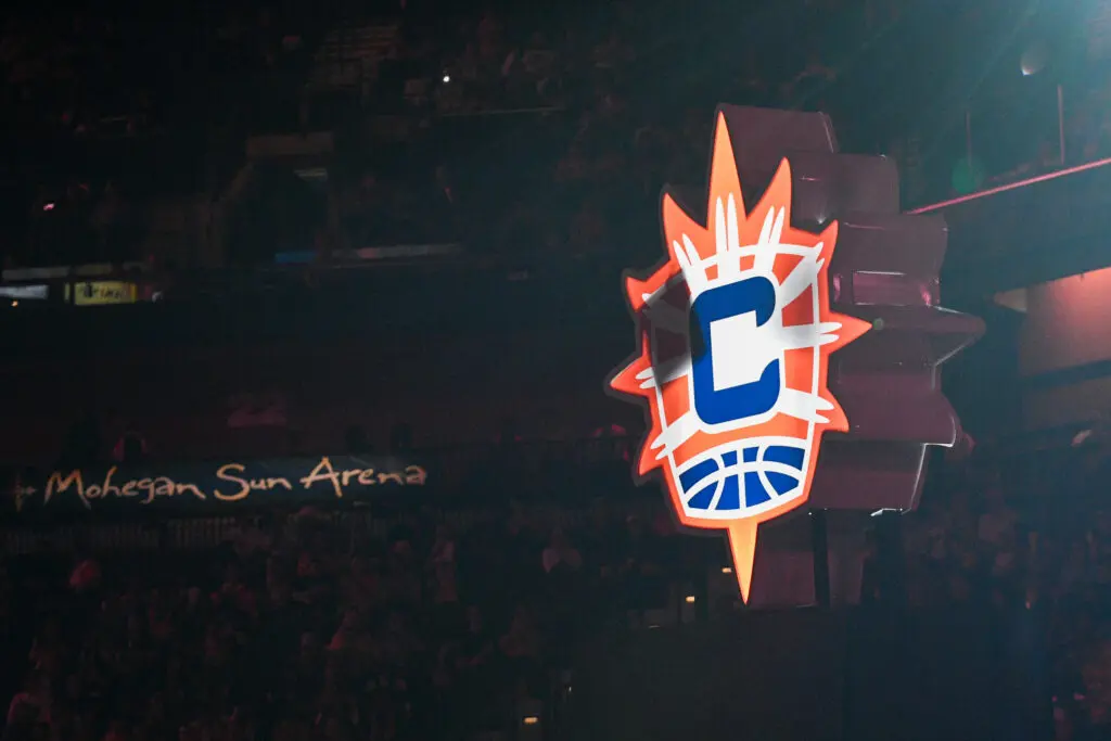 The logos for the Connecticut Sun and their Uncasville home at Mohegan Sun Arena are displayed before a 2025 WNBA game.