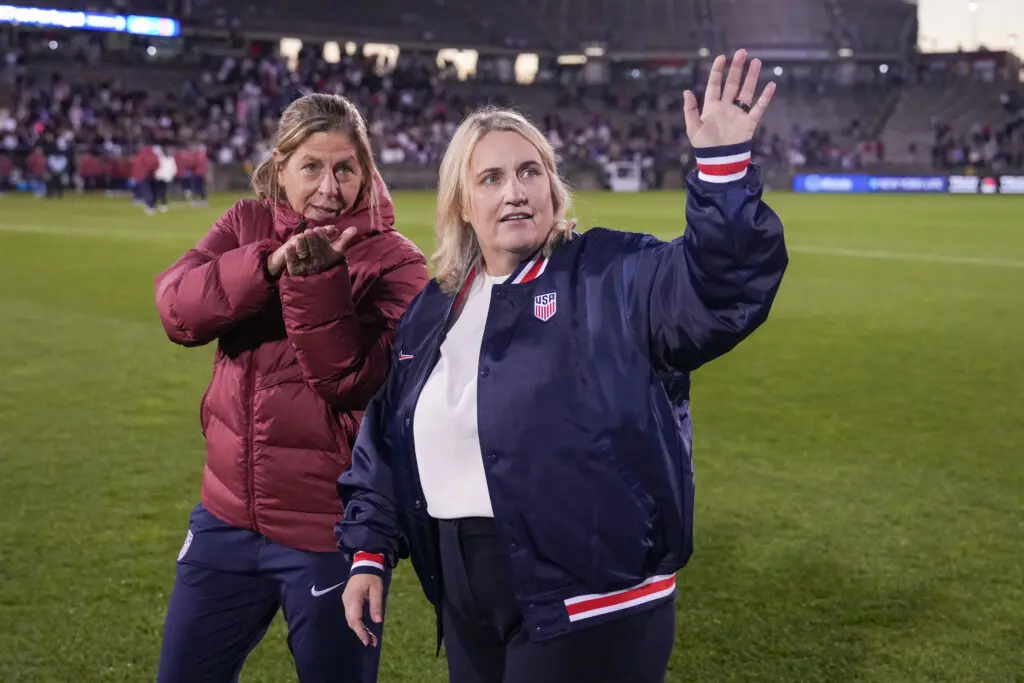 USWNT assistant coach Denise Reddy and head coach Emma Hayes wave to the crowd after a 2025 friendly.