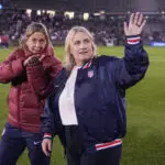 USWNT assistant coach Denise Reddy and head coach Emma Hayes wave to the crowd after a 2025 friendly.