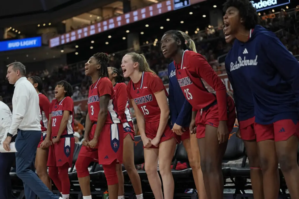 University of Richmond bench players celebrate a play during a 2025/26 NCAA women's basketball game.