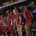 University of Richmond bench players celebrate a play during a 2025/26 NCAA women's basketball game.