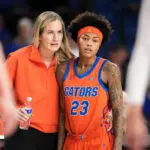 Florida head coach Kelly Rae Finley gives notes to sophomore guard Liv McGill during a 2025/26 NCAA basketball game.