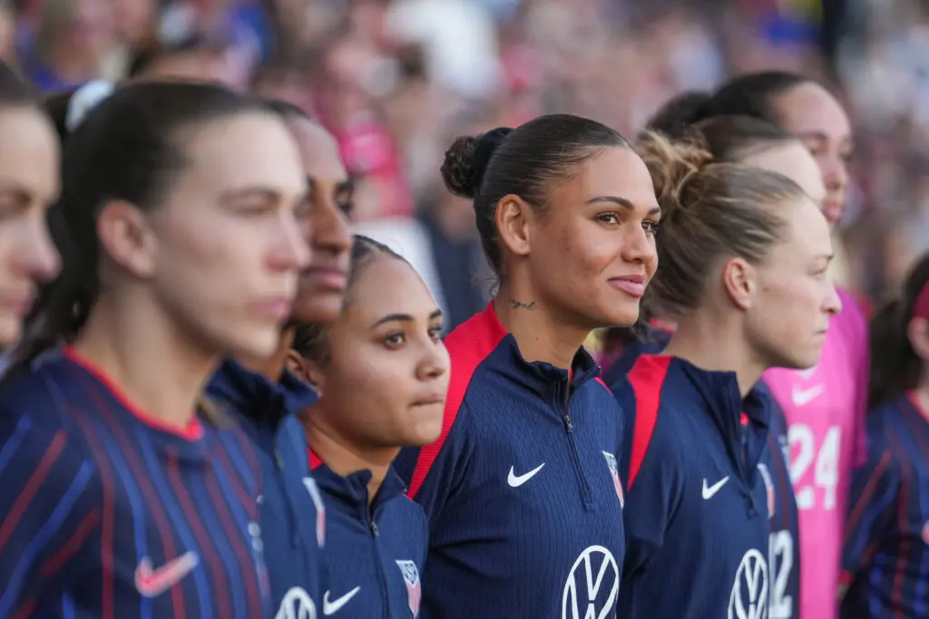 USWNT forwards Alyssa Thompson and Trinity Rodman look on from the sideline before their 2026 SheBelieves Cup opener.