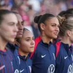 USWNT forwards Alyssa Thompson and Trinity Rodman look on from the sideline before their 2026 SheBelieves Cup opener.