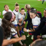 USWNT players huddle before a 2026 SheBelieves Cup match.