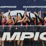 The USWNT cheers as captains Lindsey Heaps and Naomi Girma lift the 2026 SheBelieves Cup.