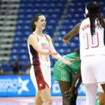 USA Basketball guard Caitlin Clark high-fives teammate Rhyne Howard during a 2026 FIBA World Cup Qualifying Tournament game vs. Senegal.