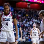 UConn freshman Blanca Quiñonez and sophomore Sarah Strong celebrate a play during the 2026 Big East women's basketball tournament championship game.
