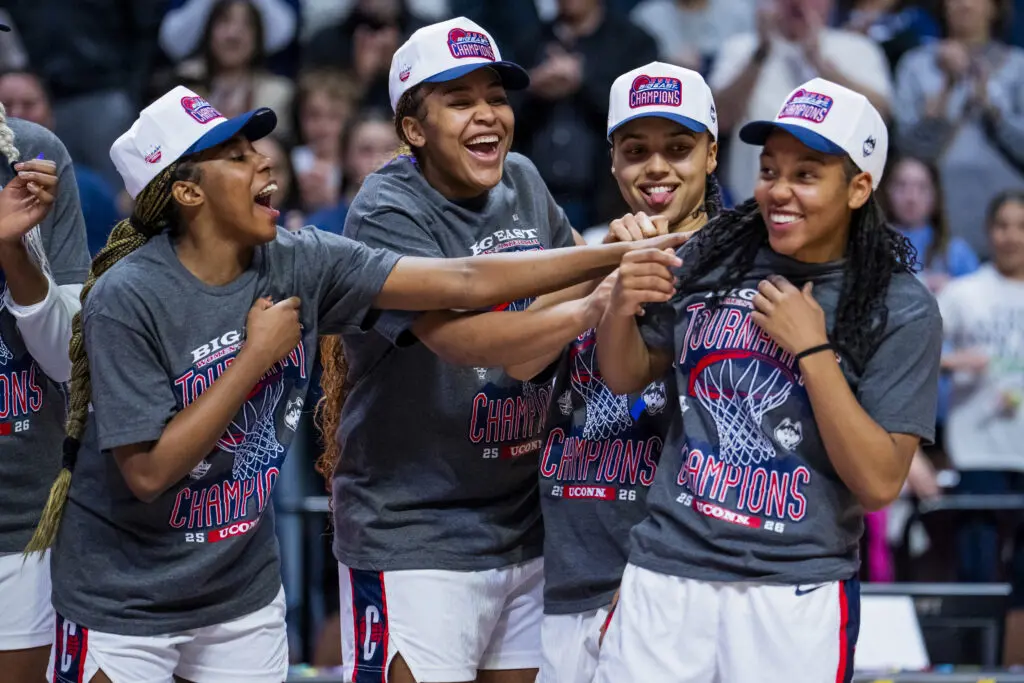 UConn women's basketball teammates Kelis Fisher, Sarah Strong, Azzi Fudd, and KK Arnold laugh and celebrate their 2026 Big East tournament title win.