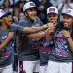 UConn women's basketball teammates Kelis Fisher, Sarah Strong, Azzi Fudd, and KK Arnold laugh and celebrate their 2026 Big East tournament title win.