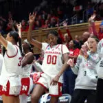 The Nebraska women's basketball bench celebrates a play during their 2026 First Four game.