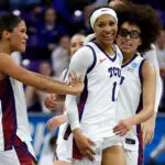 Taylor Bigby #1 of the TCU Horned Frogs celebrates with teammates Donovyn Hunter #4 and Olivia Miles #5 in the first half against the UC San Diego Tritons during the first round of the NCAA Women's Basketball Tournament on March 20, 2026 in Fort Worth, Texas.