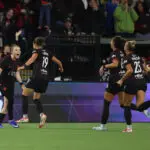 Portland Thorns forward Pietra Tordin celebrates her goal with midfielder Olivia Moultrie and other teammates during a 2026 NWSL match.