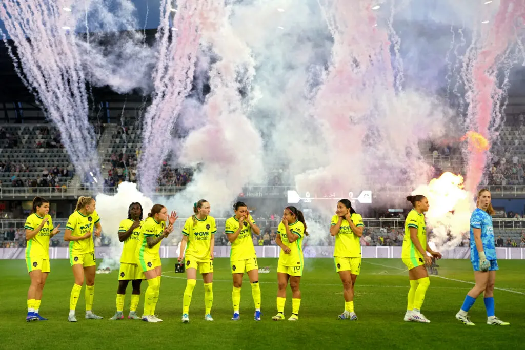 The visiting Washington Spirit react to fireworks before opponent Racing Louisville's 2026 NWSL home opener.