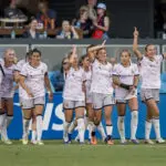 Angel City teammates celebrate a goal during a 2026 NWSL match.