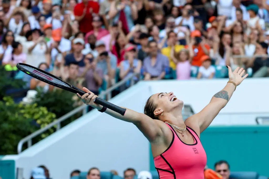 Aryna Sabalenka looks up with her arms raised after winning the 2026 Miami Open.